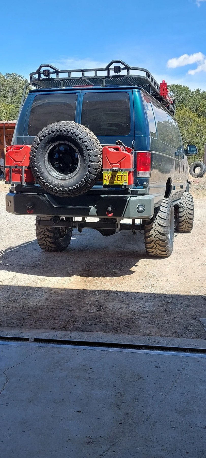 Rear view of custom blue 4x4 van